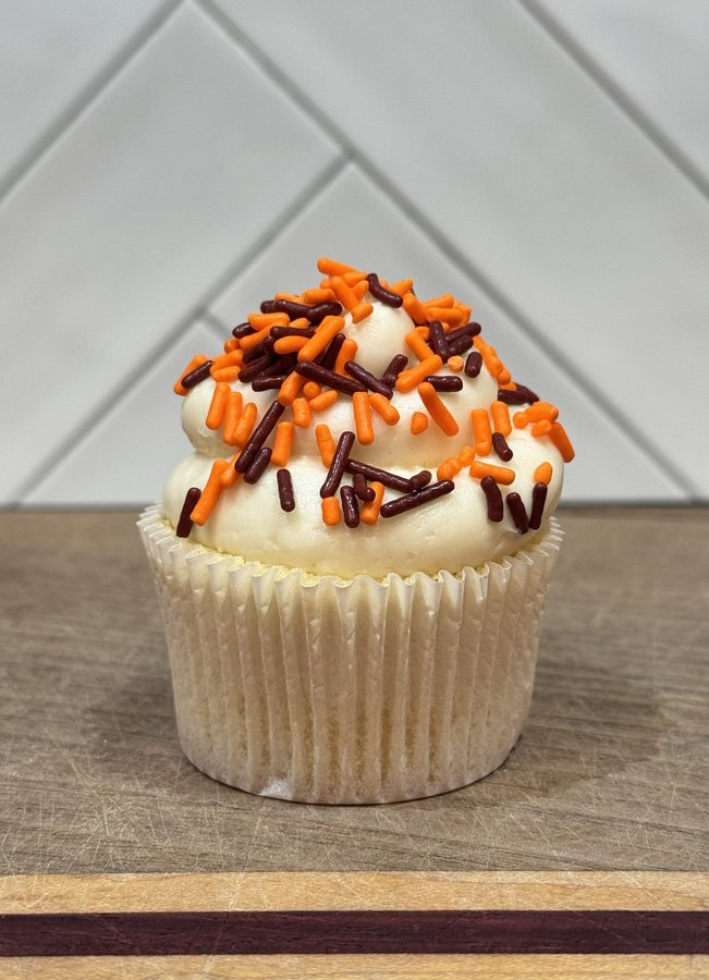 Celebration Sprinkles cupcake with maroon and orange sprinkles