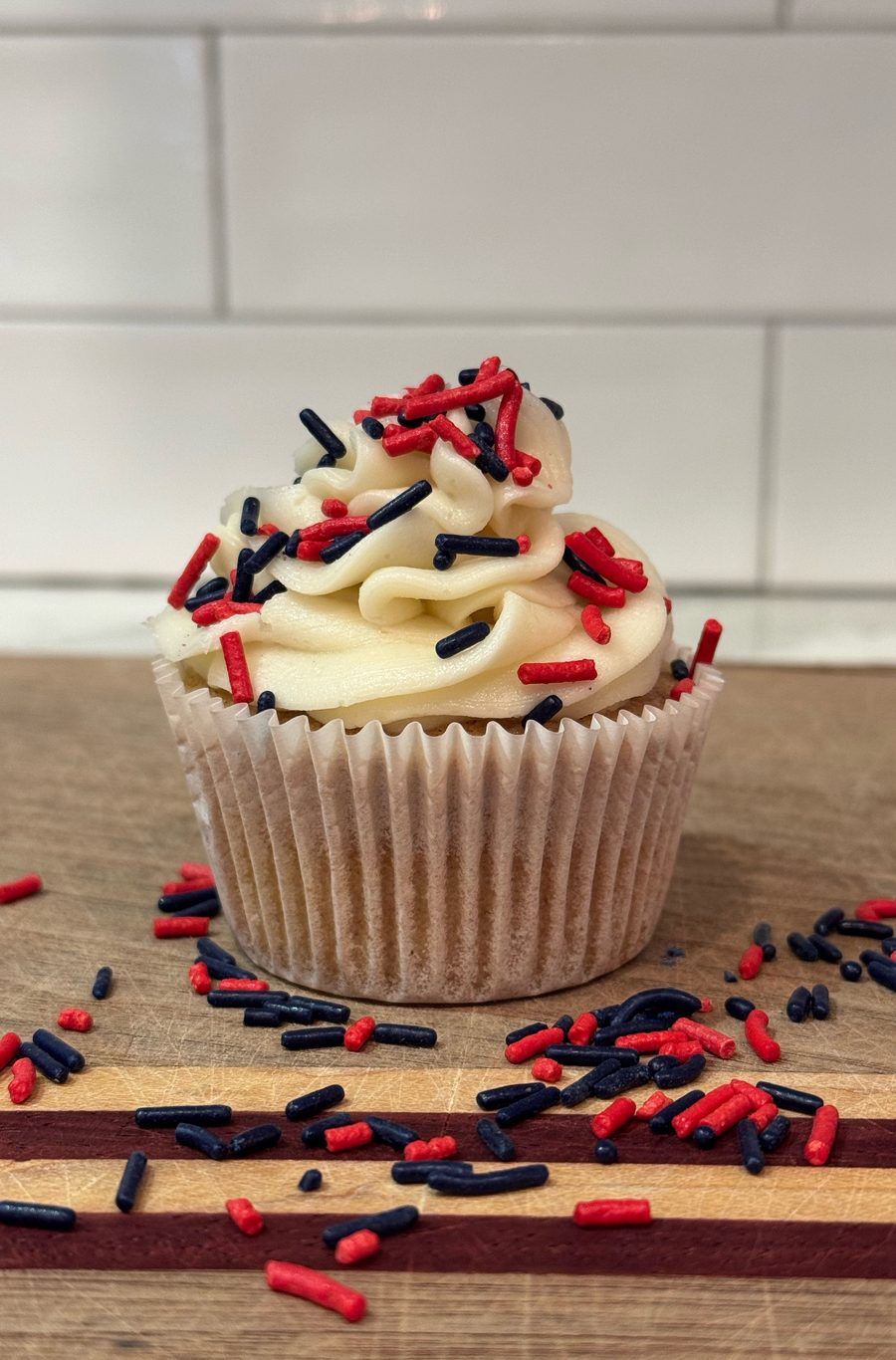 Celebration Sprinkles cupcake with red and navy sprinkles